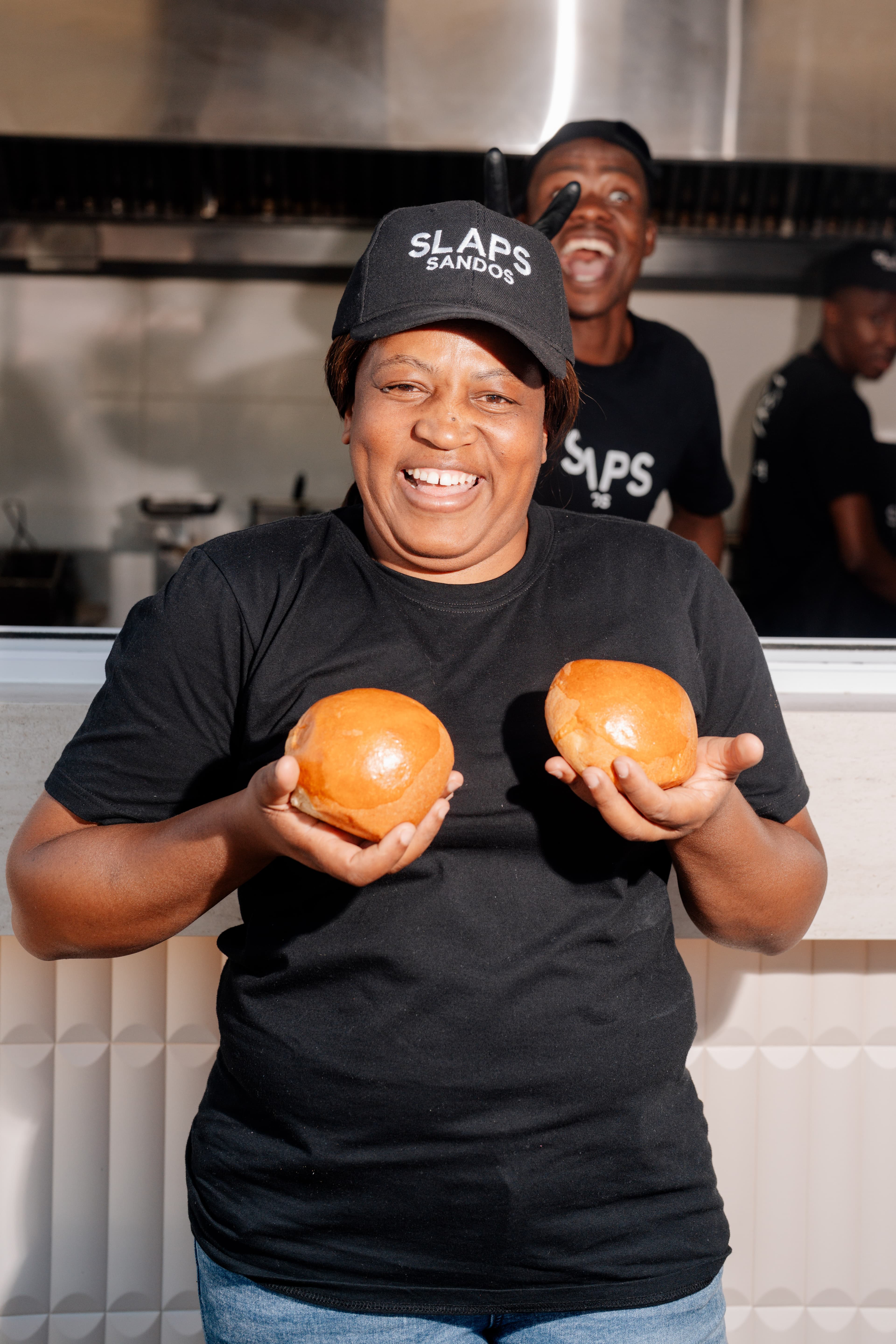 A SLAPS Sandos team member carefully plating a sando