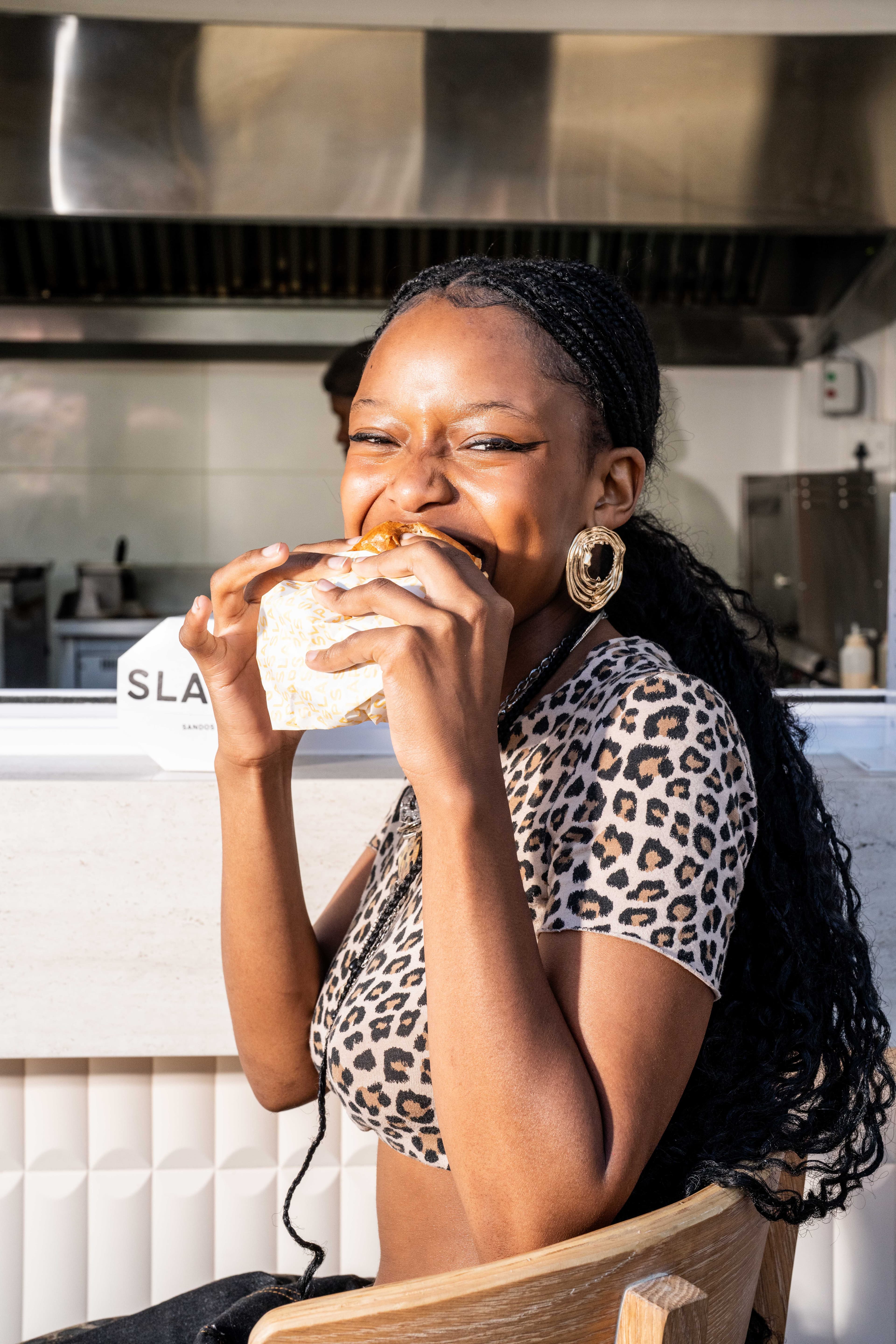 A customer happily eating a SLAPS sando